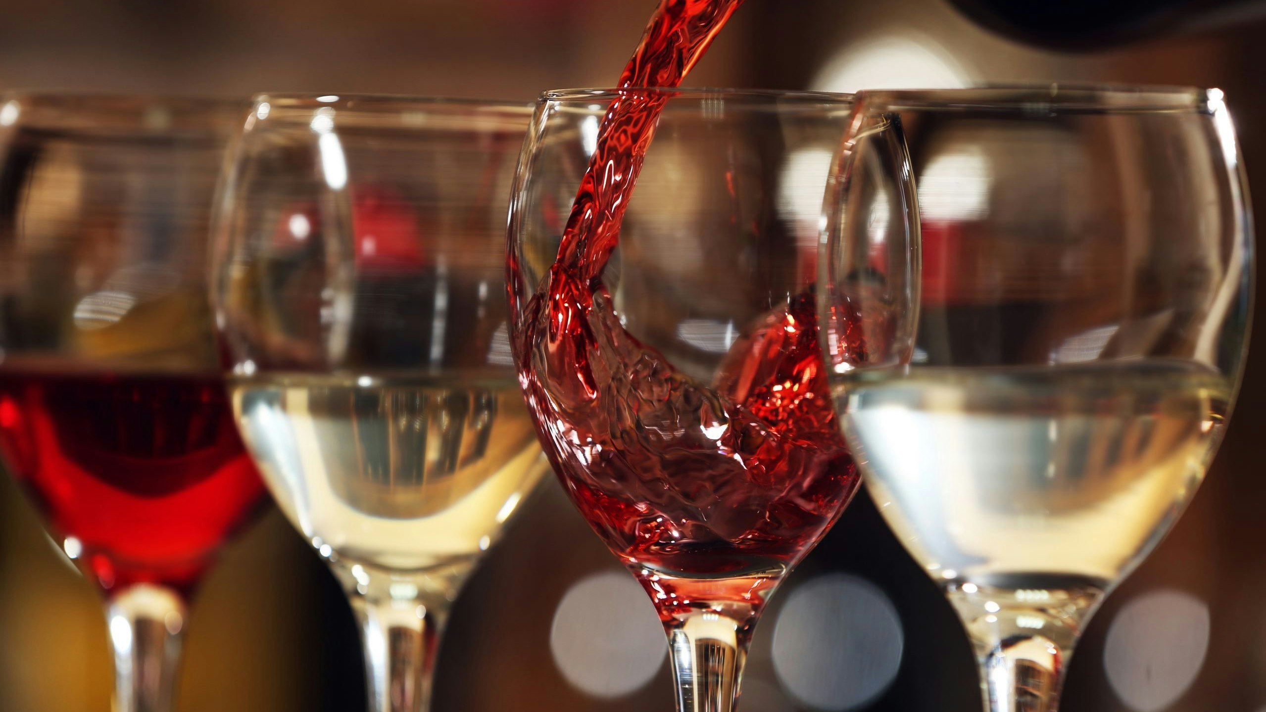 Four glasses filled with red and white wine