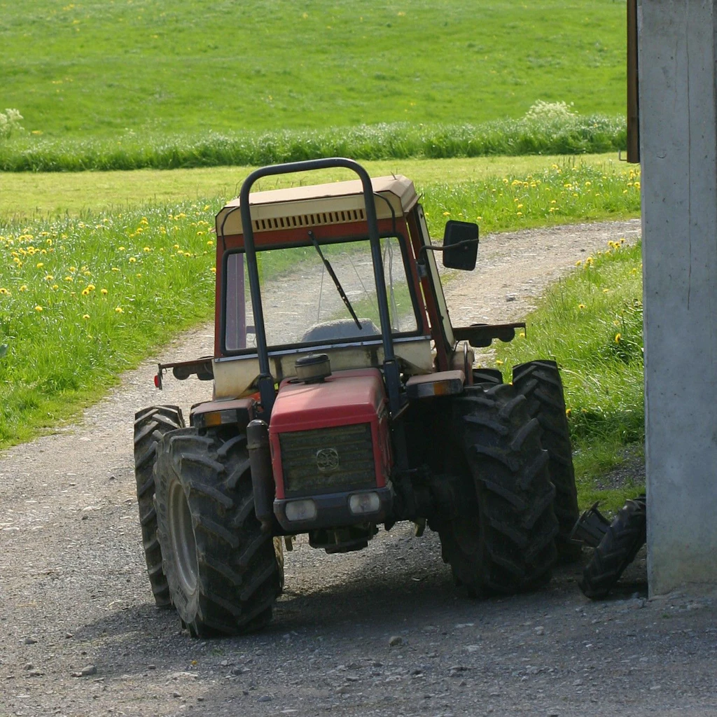 Tractor next to a farm