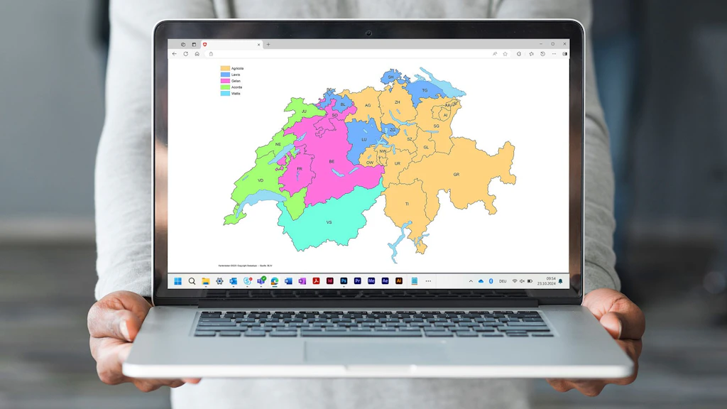 Une image de toute la Suisse divisée en couleurs est affichée sur un ordinateur portable.